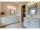 Elegant bathroom featuring dual vanities, quartz countertops, and a walk-in closet, providing ample space and style at 2826 Riders Pass, Odessa, FL 33556