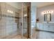 Spa-like bathroom showcasing a glass-enclosed shower, soaking tub, and double vanity, creating a relaxing retreat at 2826 Riders Pass, Odessa, FL 33556