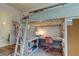 Bedroom features a loft bed with under-desk workspace, chair and decor at 2826 Riders Pass, Odessa, FL 33556