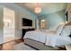 Luxurious bedroom with a king-size bed, chandelier, and a glimpse into an elegant bathroom, offering comfort and style at 2826 Riders Pass, Odessa, FL 33556