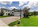 Charming two-story home with a three car garage, beautiful landscaping, and a basketball hoop on the driveway at 2826 Riders Pass, Odessa, FL 33556