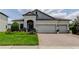 Charming single-story home boasts a three-car garage and professional landscaping at 2826 Riders Pass, Odessa, FL 33556