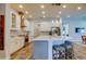 Well-lit kitchen boasts an island with seating, stainless steel appliances, and white cabinetry at 2826 Riders Pass, Odessa, FL 33556