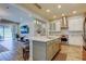 Open kitchen featuring a large island, stainless steel appliances, and bright lighting at 2826 Riders Pass, Odessa, FL 33556
