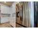 Stainless steel refrigerator complementing the white cabinetry and countertops in this modern kitchen at 2826 Riders Pass, Odessa, FL 33556