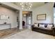 Elegant living room featuring modern lighting, hardwood floors, and views into the foyer with a piano at 2826 Riders Pass, Odessa, FL 33556