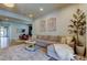 Cozy living room with comfortable sofa, stylish artwork, and easy access to the dining area at 2826 Riders Pass, Odessa, FL 33556