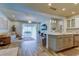 Open-concept living space with hardwood floors and views into the kitchen and outdoor screened-in patio area at 2826 Riders Pass, Odessa, FL 33556