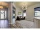 Living room featuring stylish light fixture and open layout, connecting to the entry way and dining area at 2826 Riders Pass, Odessa, FL 33556