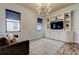 Living room with modern entertainment center, built-in shelving, and large windows at 2826 Riders Pass, Odessa, FL 33556