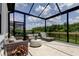 Screened in patio featuring outdoor seating overlooking the backyard at 2826 Riders Pass, Odessa, FL 33556