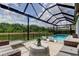 Covered patio and lounge seating overlooking the backyard and pool with lounge seating at 2826 Riders Pass, Odessa, FL 33556