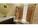 Full bathroom featuring tiled walk-in shower with decorative curtain, vanity and toilet at 3086 Pointer Dr, Palm Harbor, FL 34683