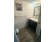 Half-bath features dark-blue vanity with marble top, matching fixtures, and modern flooring at 3086 Pointer Dr, Palm Harbor, FL 34683