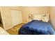 This bright bedroom has a double closet, single bed, and wooden floors at 3086 Pointer Dr, Palm Harbor, FL 34683
