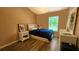 This is a cozy bedroom with a single bed, wooden floors and great light at 3086 Pointer Dr, Palm Harbor, FL 34683