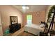 Cozy bedroom with light-colored walls, hardwood floors, and a window providing natural light at 3086 Pointer Dr, Palm Harbor, FL 34683