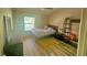 Inviting bedroom with hardwood floors, a ceiling fan and large window at 3086 Pointer Dr, Palm Harbor, FL 34683