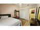 This bedroom features light pink walls, light hardwood floors, and ladder-style shelving at 3086 Pointer Dr, Palm Harbor, FL 34683