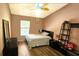 This cozy bedroom features wooden floors, a ceiling fan, and a single bed at 3086 Pointer Dr, Palm Harbor, FL 34683