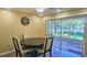 A charming dining area showcases a round table, four chairs, and sliding doors to the porch at 3086 Pointer Dr, Palm Harbor, FL 34683