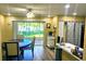 A well-lit dining area features a ceiling fan, sliding glass doors, and wood-look flooring at 3086 Pointer Dr, Palm Harbor, FL 34683