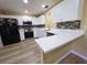 Bright kitchen features white cabinetry, stainless steel appliances, and modern countertops at 3086 Pointer Dr, Palm Harbor, FL 34683