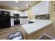 Bright kitchen features white cabinetry, stainless steel appliances, and modern countertops at 3086 Pointer Dr, Palm Harbor, FL 34683