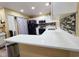 Bright kitchen featuring quartz countertops, stainless steel appliances, and tile backsplash at 3086 Pointer Dr, Palm Harbor, FL 34683