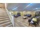 Spacious living room featuring wood flooring, recessed lighting, and stairs leading to the upper level at 3086 Pointer Dr, Palm Harbor, FL 34683