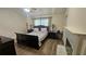 This is a tranquil main bedroom with a fireplace, wooden floors and neutral tones at 3086 Pointer Dr, Palm Harbor, FL 34683