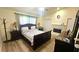 This is a tranquil main bedroom with a fireplace, wooden floors and neutral tones at 3086 Pointer Dr, Palm Harbor, FL 34683