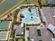 Drone shot of the community pool, bocce ball court, shuffleboard court, surrounded by tropical landscaping at 31354 Cabana Rye Ave, San Antonio, FL 33576