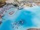 Aerial view of the lagoon featuring beach umbrellas, white sand beach, and an inflatable obstacle course at 31354 Cabana Rye Ave, San Antonio, FL 33576