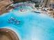 Lagoon aerial with inflatables, slides, paddleboards, restaurant, and a white sand beach at 31354 Cabana Rye Ave, San Antonio, FL 33576