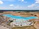 An aerial view of the community lagoon, beach, cabanas, and inflatables on a sunny day at 31354 Cabana Rye Ave, San Antonio, FL 33576