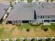 Aerial view of home featuring a well-manicured backyard with screened-in porch and luscious green grass at 31354 Cabana Rye Ave, San Antonio, FL 33576