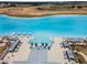 Aerial view of community pool featuring lounge seating, umbrellas, cabanas and palm trees at 31354 Cabana Rye Ave, San Antonio, FL 33576