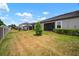 The large backyard features a well manicured lawn and view of the screened-in porch at 31354 Cabana Rye Ave, San Antonio, FL 33576
