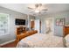 View of the bedroom with hardwood floors, a ceiling fan, and access to the bathroom and the living room at 31354 Cabana Rye Ave, San Antonio, FL 33576