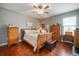 Charming bedroom featuring hardwood floors, a ceiling fan, and classic wooden furniture at 31354 Cabana Rye Ave, San Antonio, FL 33576