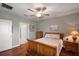 Comfortable bedroom boasting a ceiling fan, hardwood floors, and lots of natural light from the window at 31354 Cabana Rye Ave, San Antonio, FL 33576