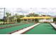 Well-kept bocce ball court with yellow canopies and landscaping for leisurely outdoor enjoyment at 31354 Cabana Rye Ave, San Antonio, FL 33576