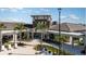 An inviting community clubhouse with lush landscaping and comfortable lounge seating on the patio at 31354 Cabana Rye Ave, San Antonio, FL 33576
