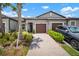 Well-maintained townhome with a brick driveway, two-car garage, and manicured landscaping at 31354 Cabana Rye Ave, San Antonio, FL 33576