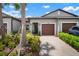 Charming townhome with a two-car garage and lush landscaping, creating a welcoming curb appeal at 31354 Cabana Rye Ave, San Antonio, FL 33576