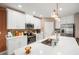 Beautiful kitchen with white cabinets, granite countertops, stainless steel appliances, and modern lighting fixtures at 31354 Cabana Rye Ave, San Antonio, FL 33576