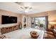 Spacious living room with a ceiling fan, sliding glass doors to the patio, and comfortable seating at 31354 Cabana Rye Ave, San Antonio, FL 33576