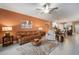 A living room flowing into the kitchen, featuring modern lighting, updated appliances, and white cabinets at 31354 Cabana Rye Ave, San Antonio, FL 33576