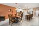 Open-concept living space with a kitchen island, dining table, and access to the patio at 31354 Cabana Rye Ave, San Antonio, FL 33576